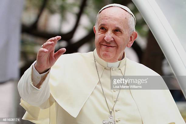 MANILA, PHILIPPINES - JANUARY 16:  Pope Francis waves to thousands of followers as he arrives at the Manila Cathedral on January 16, 2015 in Manila, Philippines. Pope Francis will visit venues across Leyte and Manila during his visit to the Philippines from January 15 - 19. The visit is expected to attract crowds in the millions as Filipino Catholics flock to catch a glimpse of the leader of the Catholic Church in the Philippines for the first time since 1995. The Pope will begin the tour in Manila, then travelling to Tacloban to visit areas devastated by Typhoon Haiyan before returning to Manila to hold a mass at Rizal Park. The Philippines is the only Catholic majority nation in Asia with around 90 percent of the population professing the faith.  (Photo by Lisa Maree Williams/Getty Images)